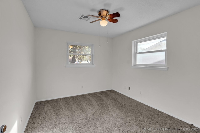 unfurnished room featuring plenty of natural light, carpet flooring, and ceiling fan