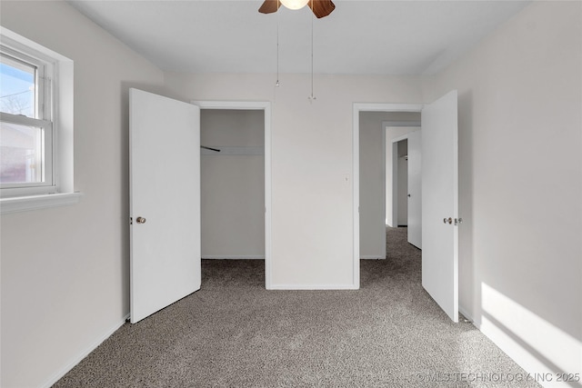 unfurnished bedroom featuring carpet, ceiling fan, and a closet