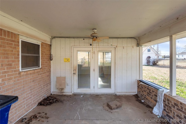 view of exterior entry featuring a patio area, ceiling fan, and french doors