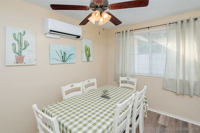 dining space with light hardwood / wood-style floors, an AC wall unit, and ceiling fan