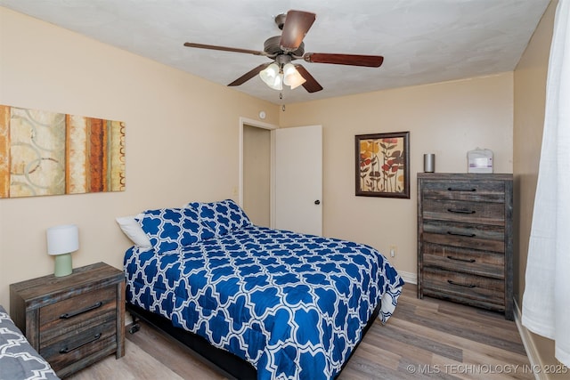 bedroom with hardwood / wood-style flooring and ceiling fan