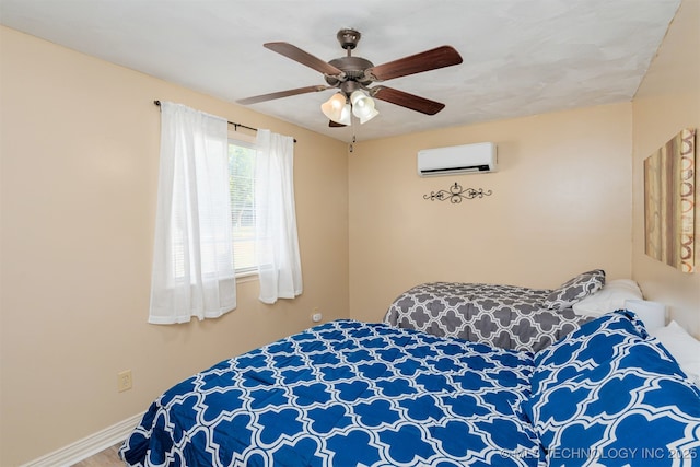 bedroom with ceiling fan and a wall mounted air conditioner