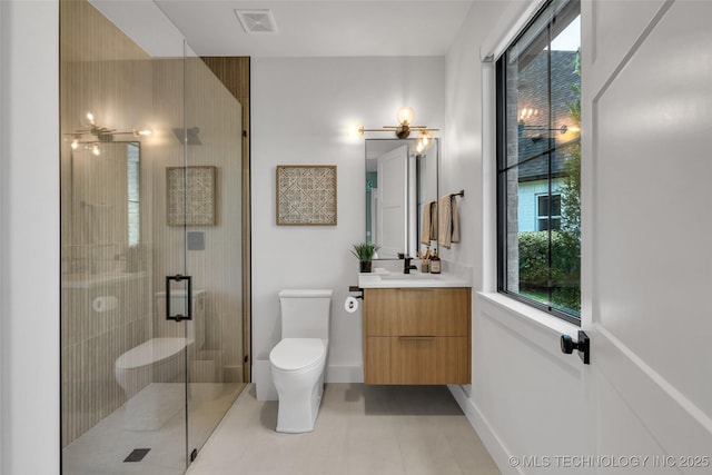 bathroom with vanity, tile patterned flooring, a shower with door, and toilet