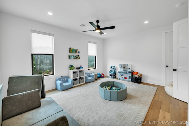 rec room featuring ceiling fan, plenty of natural light, and light hardwood / wood-style floors