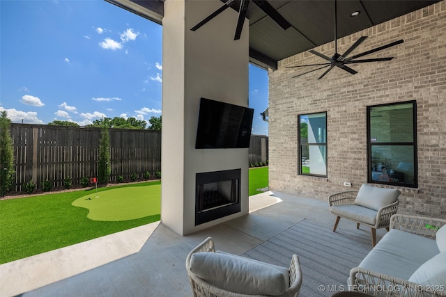 view of patio with ceiling fan and exterior fireplace