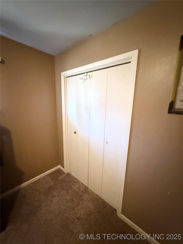 unfurnished bedroom with carpet floors and a closet