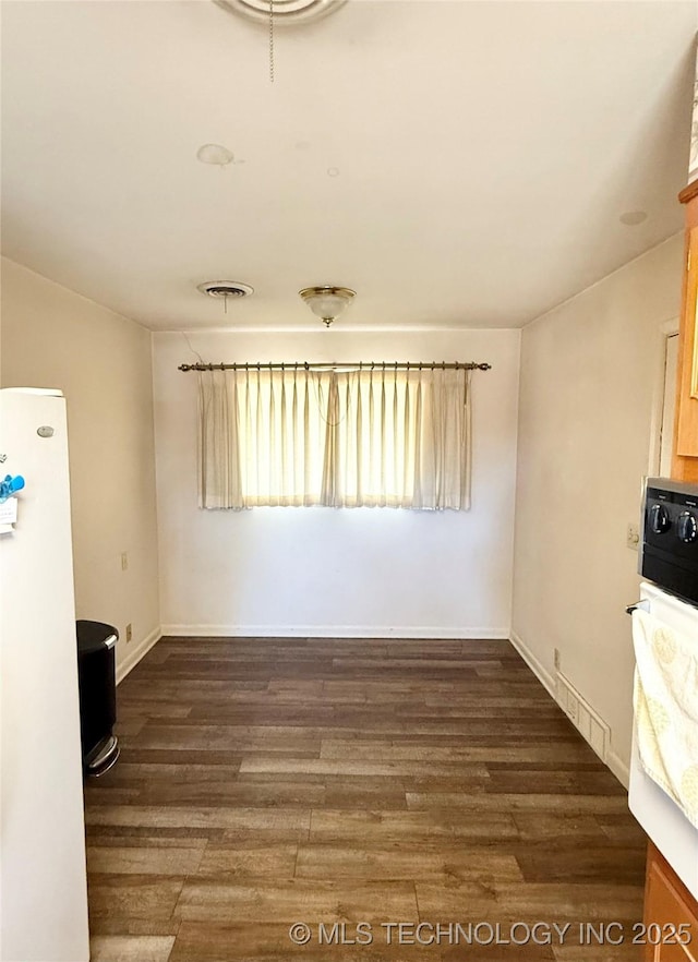 unfurnished dining area with dark hardwood / wood-style floors