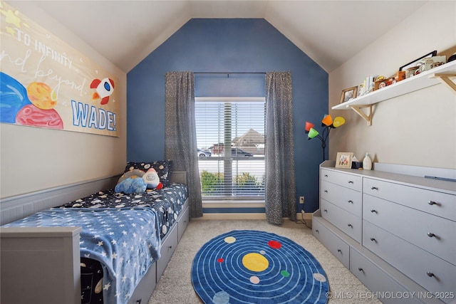 bedroom with vaulted ceiling and light carpet