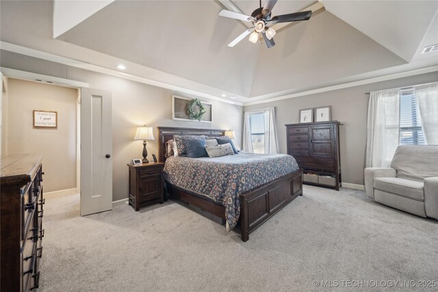 carpeted bedroom with ceiling fan and a tray ceiling