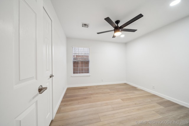 spare room with light hardwood / wood-style flooring and ceiling fan