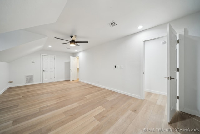 additional living space with ceiling fan, lofted ceiling, and light wood-type flooring