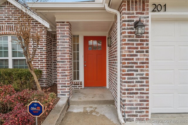 doorway to property with a garage