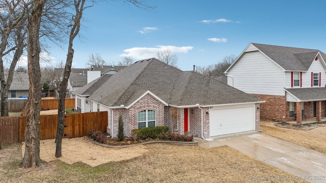 view of property featuring a garage and a front lawn