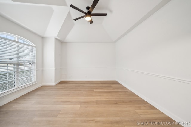 unfurnished room with lofted ceiling, light hardwood / wood-style floors, and ceiling fan