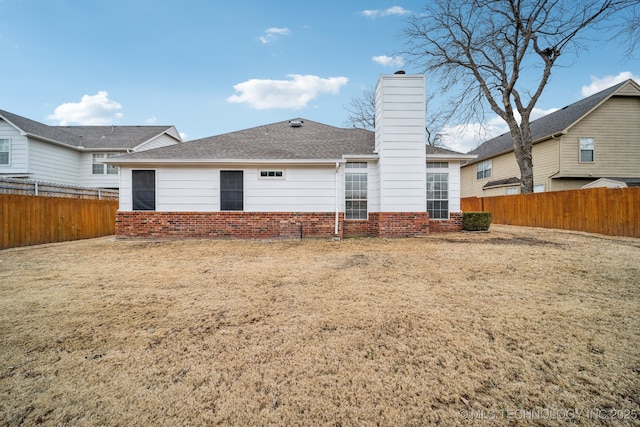 rear view of house featuring a lawn