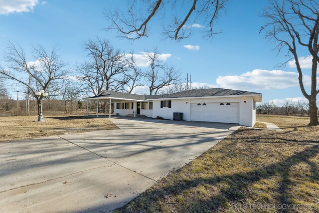 view of front of property with a garage, central AC, and covered porch