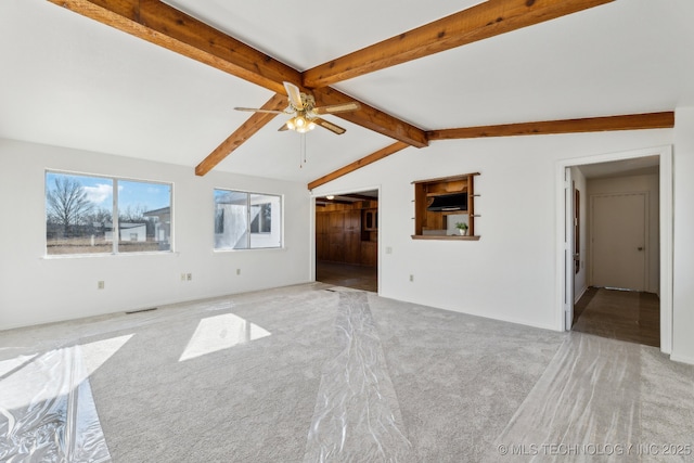 unfurnished living room with vaulted ceiling with beams, ceiling fan, carpet, and visible vents