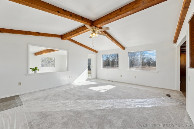 carpeted empty room featuring vaulted ceiling with beams and ceiling fan