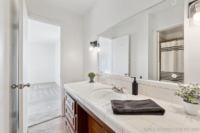 full bathroom featuring tile patterned flooring and vanity