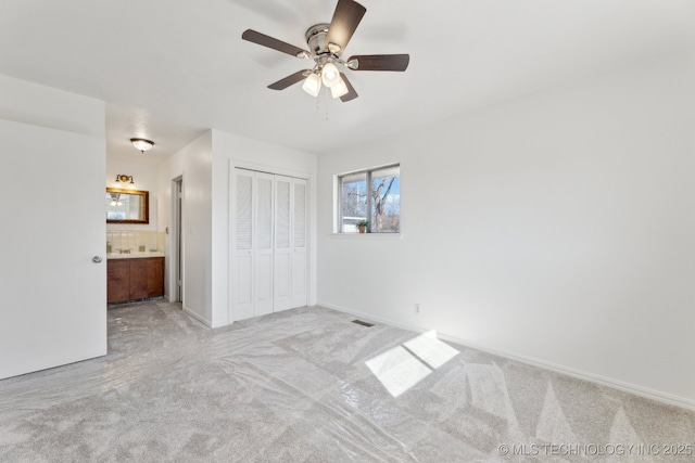 10541 Sahoma Lake Rd, Sapulpa, OK 74066 - unfurnished bedroom with carpet, a closet, ensuite bath, and ceiling fan