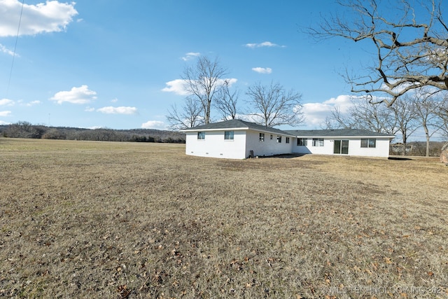 rear view of house with a yard