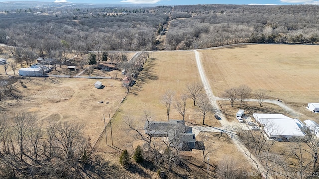 drone / aerial view featuring a rural view and a view of trees