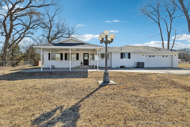 ranch-style house with a garage, covered porch, fence, driveway, and a front lawn