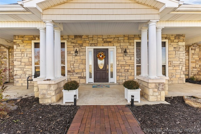 view of exterior entry featuring a porch