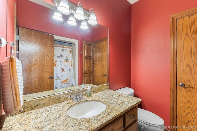 bathroom with vanity and toilet