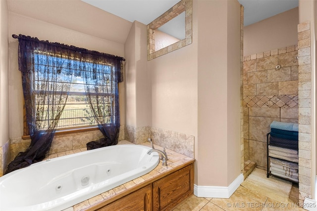 bathroom with tile patterned flooring and a washtub