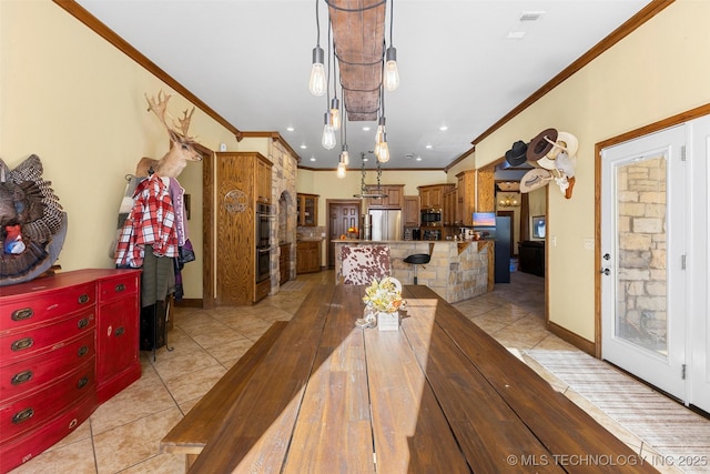 dining area featuring crown molding and light tile patterned flooring