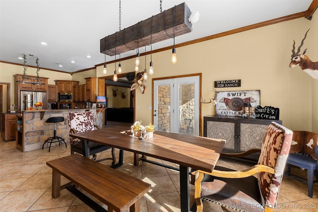 dining room featuring crown molding and light tile patterned flooring