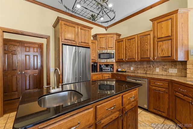 kitchen with light tile patterned floors, appliances with stainless steel finishes, sink, and backsplash