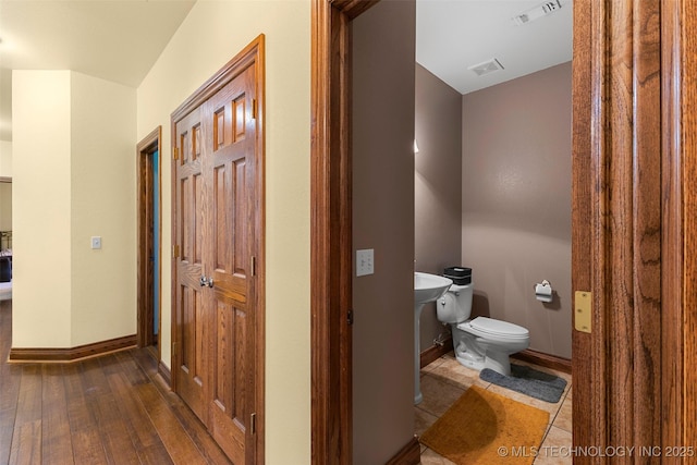 bathroom with wood-type flooring and toilet