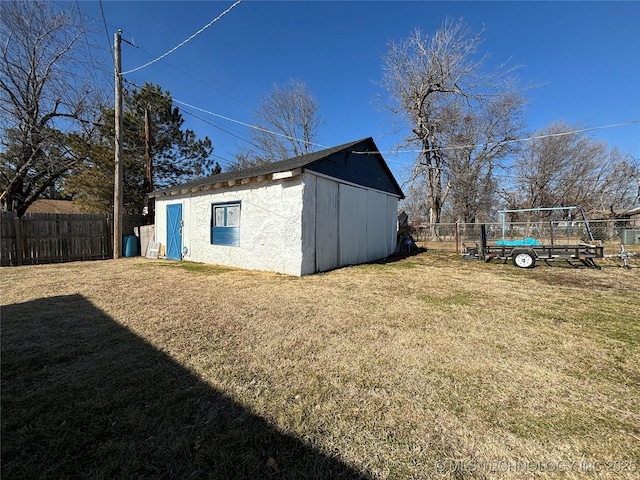 view of outbuilding featuring a lawn