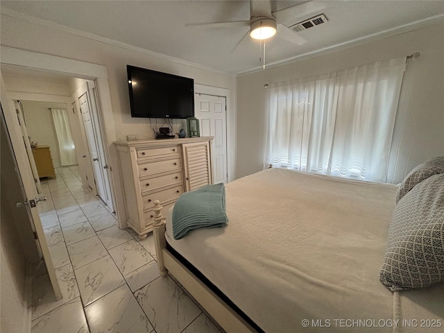 bedroom featuring ornamental molding, a closet, and ceiling fan