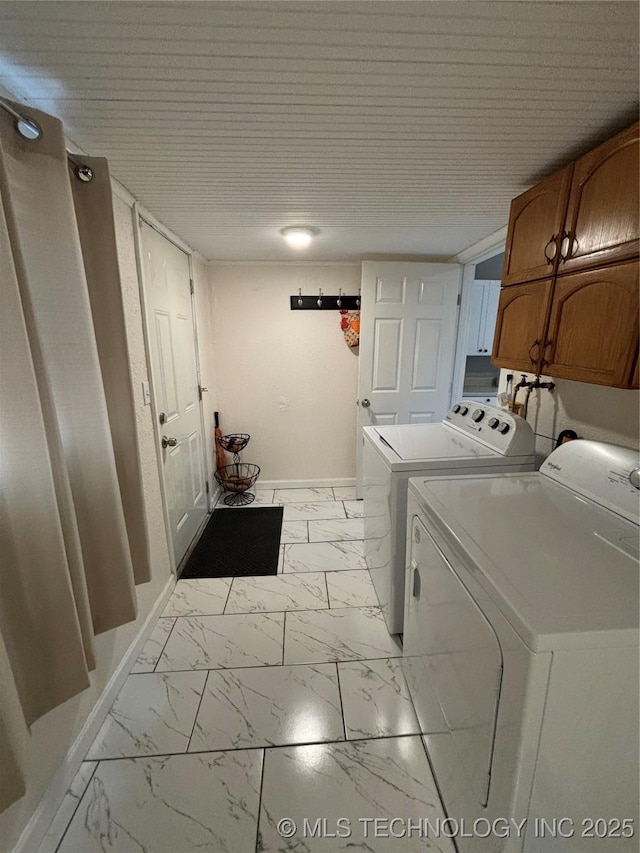 washroom featuring cabinets and washer and dryer