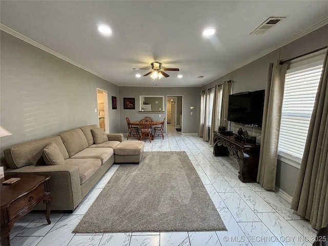 living room with ceiling fan and ornamental molding