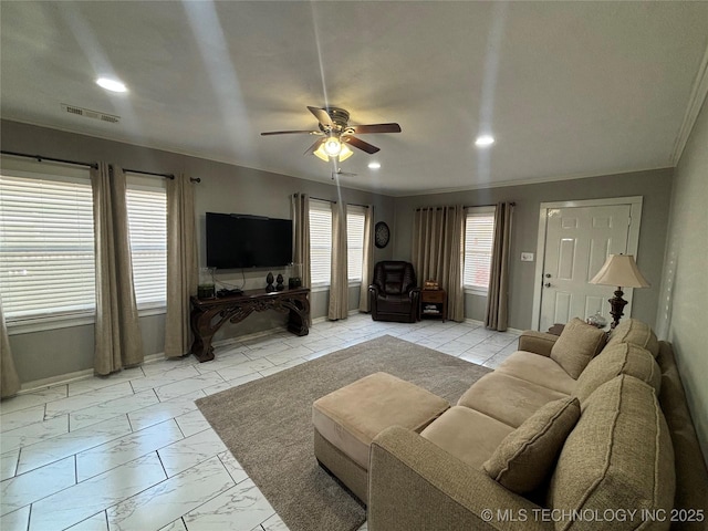 living room with ceiling fan and a wealth of natural light