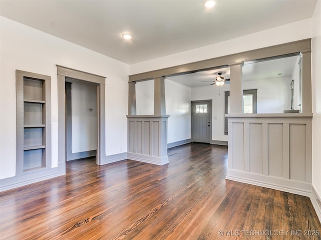 unfurnished living room with dark hardwood / wood-style floors, built in features, and ceiling fan