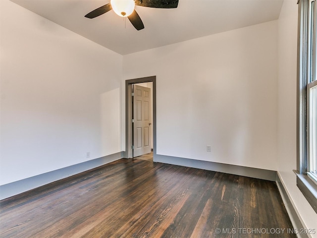 unfurnished room featuring dark hardwood / wood-style floors and ceiling fan