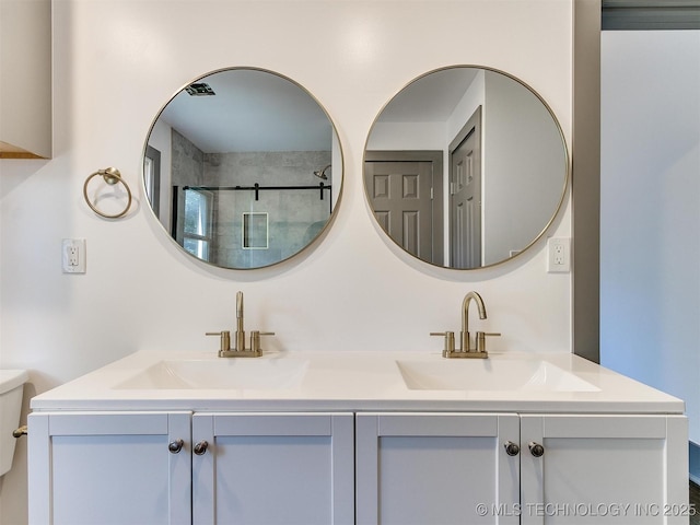 bathroom with vanity, an enclosed shower, and toilet