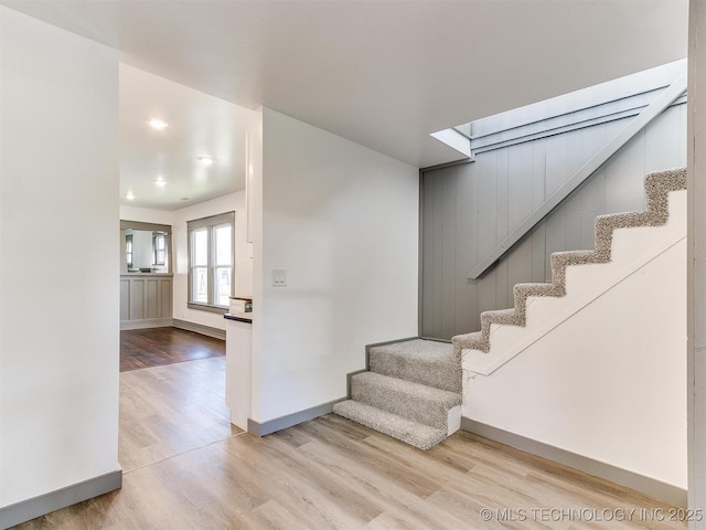 staircase with hardwood / wood-style floors