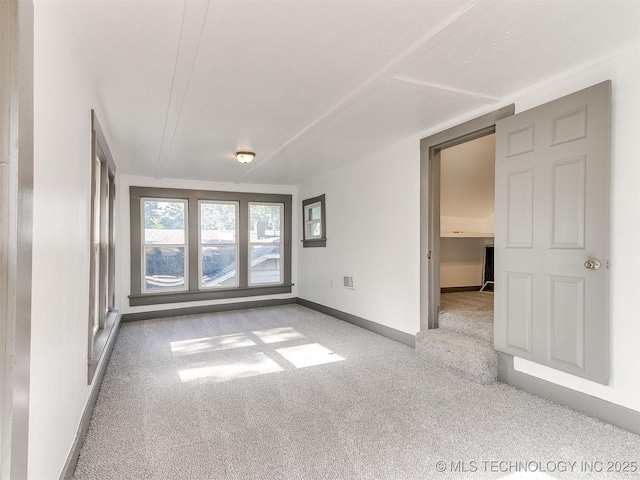 unfurnished room with light colored carpet