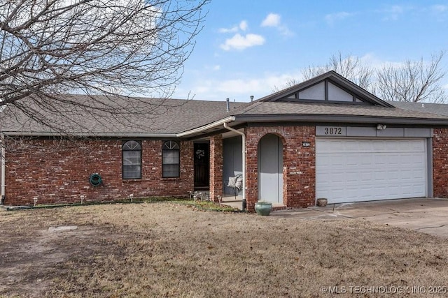 ranch-style home with a garage and a front yard