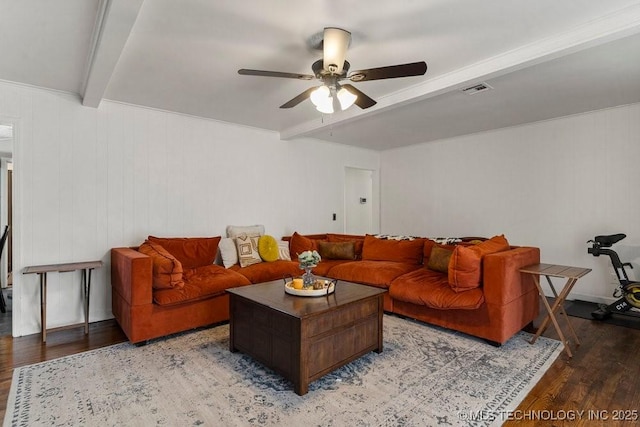 living room featuring hardwood / wood-style flooring, ceiling fan, and beam ceiling