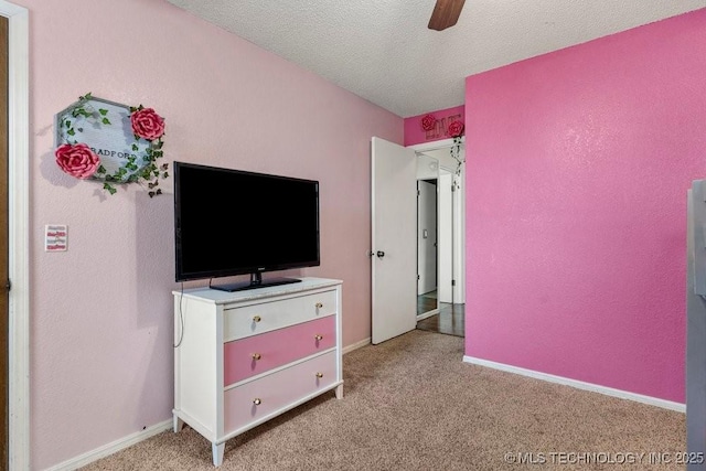 carpeted bedroom featuring a textured ceiling and ceiling fan