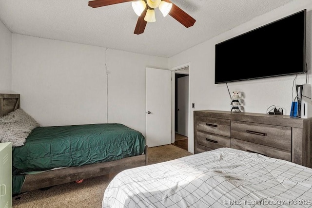 carpeted bedroom with a textured ceiling and ceiling fan