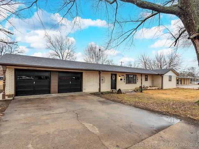 ranch-style house with a garage and a front lawn