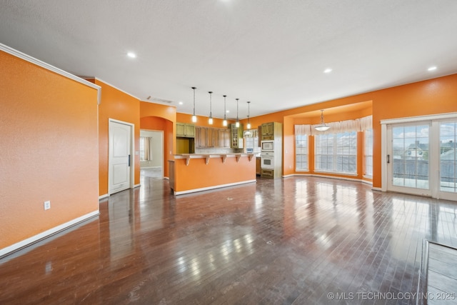 unfurnished living room with dark hardwood / wood-style floors